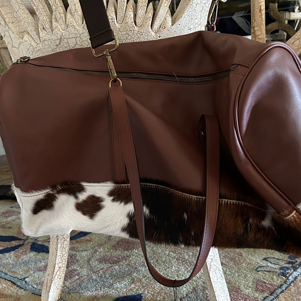 Elegant Brown Leather Duffel Bag with Cowhide Accents